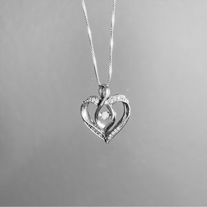 Sterling silver .11 carat diamond heart necklace. Dancing diamond. 16 diamonds